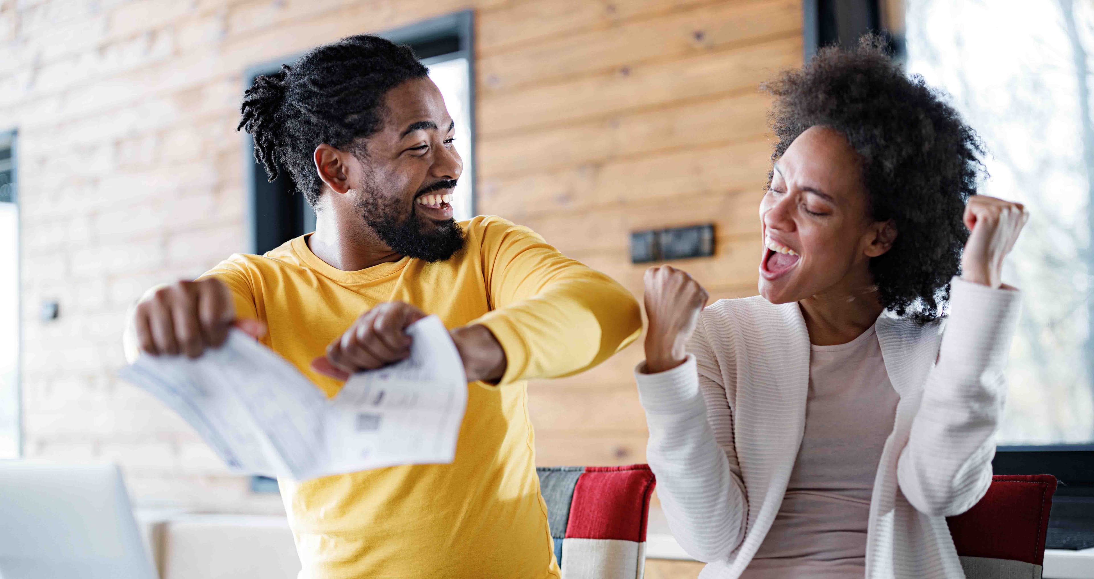 Man and woman celebrating paying their bills